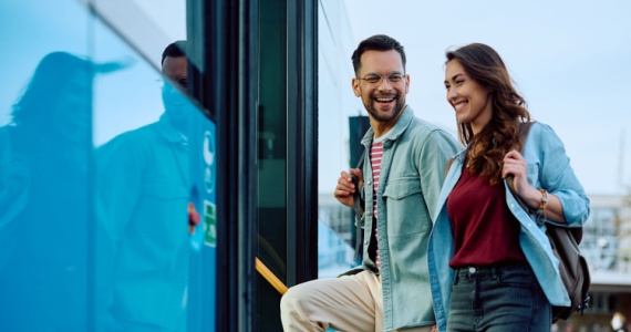 two adults board a charter bus in Houston
